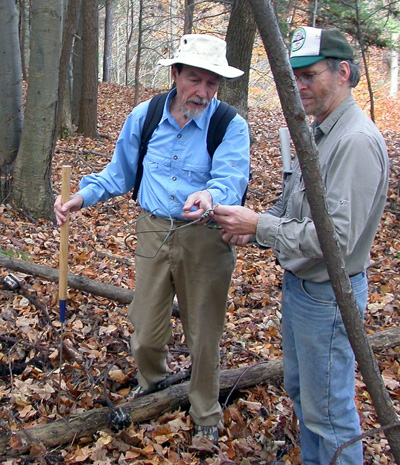 Mead in the field on an industrial archeology expedition explaining 
Mead in the field on an industrial archeology expedition explaining 
early lineman techniques to Bruce Whistance.