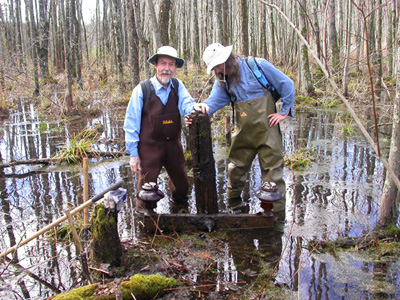Mead and Mike Spadafora with a 1912 crossarm they 
discovered in a swamp in upstate New York.